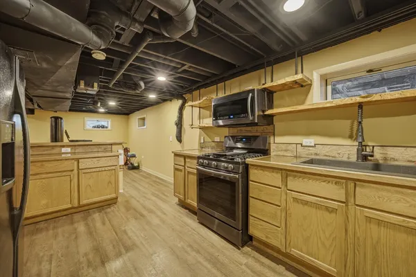 a kitchen with stainless steel appliances granite countertop a sink and cabinets