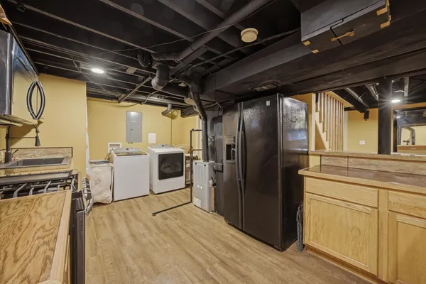 a view of a kitchen with wooden floor