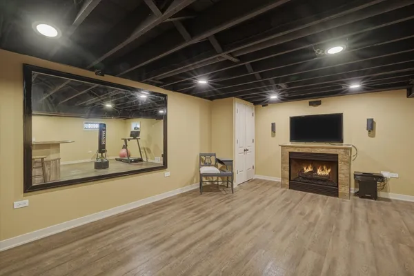 a view of a livingroom with a fireplace and wooden floor