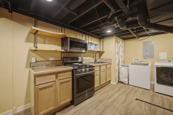 a kitchen with a stove top oven a sink and dishwasher