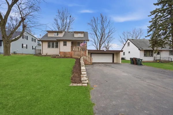 a view of house with a yard