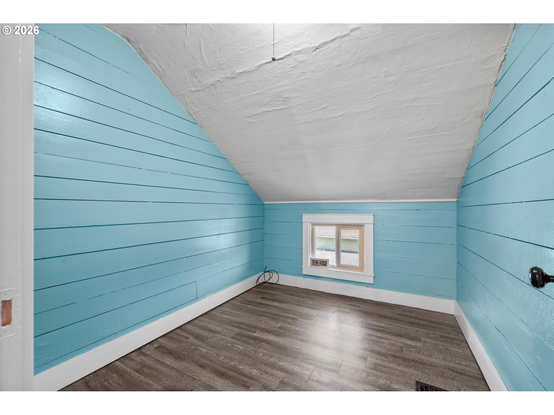 240 Southwest Bryant Street Clatskanie, OR 97016 - Photo 21 of 30 a view of an empty room with a window and wooden floor