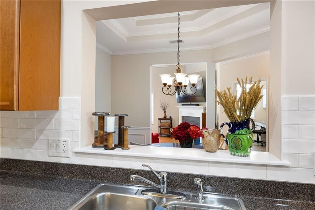 3807 Abbott Lane Southwest, Unit 15 Powder Springs, GA 30127 - Photo 15 of 32 a kitchen with a sink and a chandelier