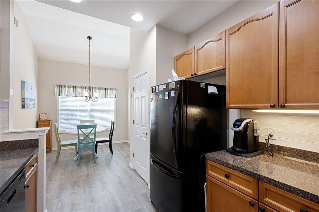 3807 Abbott Lane Southwest, Unit 15 Powder Springs, GA 30127 - Photo 16 of 32 a kitchen with a refrigerator a sink and wooden floor
