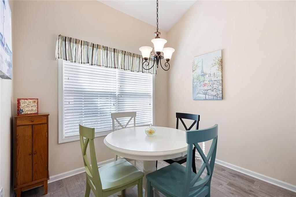 3807 Abbott Lane Southwest, Unit 15 Powder Springs, GA 30127 - Photo 17 of 32 a view of a dining room with furniture and wooden floor