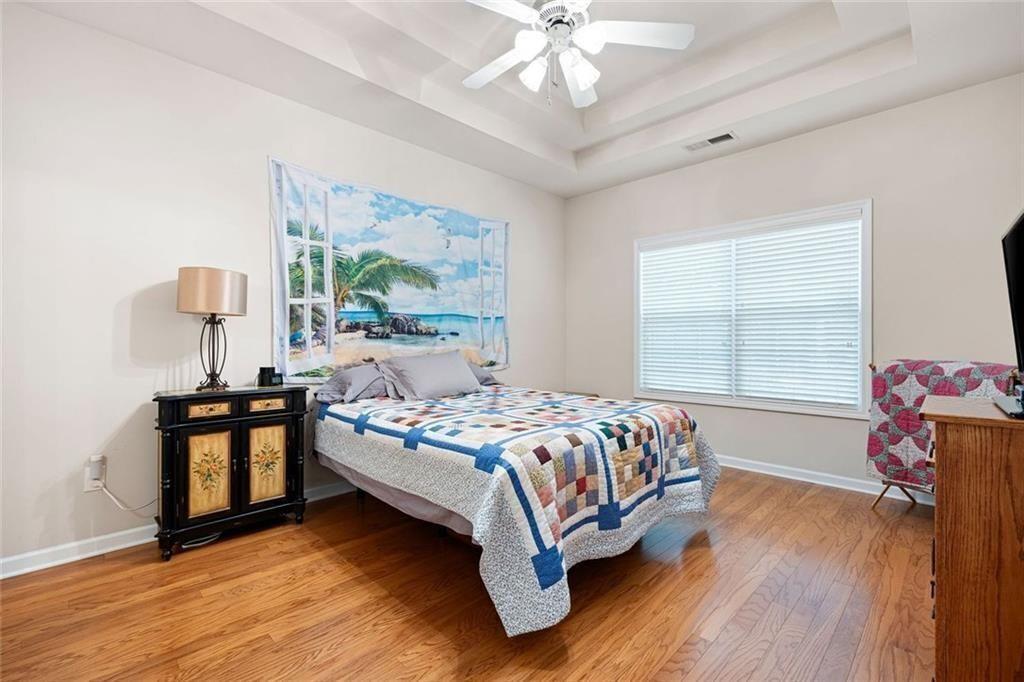 3807 Abbott Lane Southwest, Unit 15 Powder Springs, GA 30127 - Photo 19 of 32 a bedroom with a bed and a chandelier