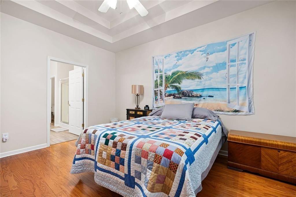 3807 Abbott Lane Southwest, Unit 15 Powder Springs, GA 30127 - Photo 20 of 32 a bedroom with a bed lamp on desk and a window