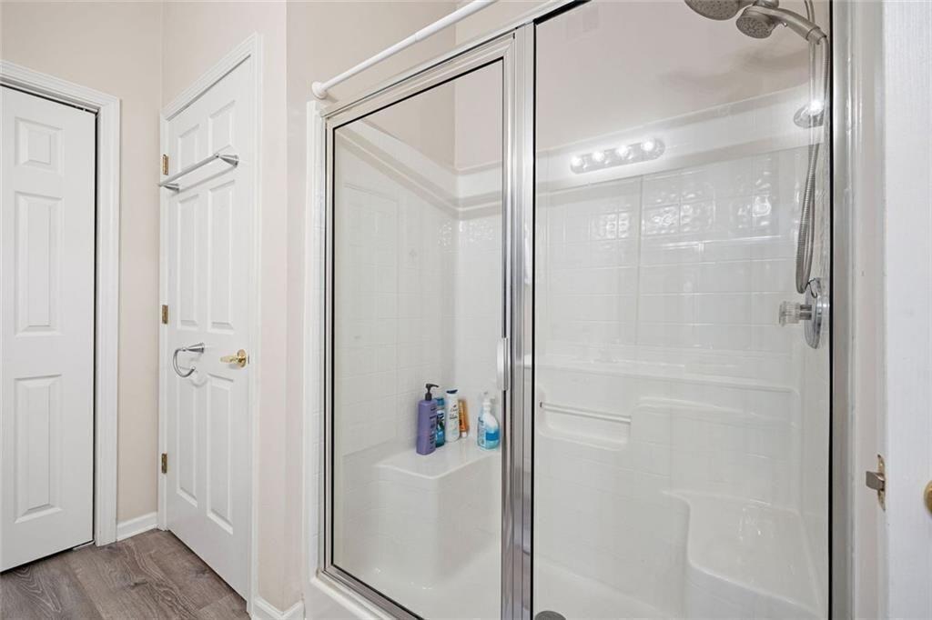 3807 Abbott Lane Southwest, Unit 15 Powder Springs, GA 30127 - Photo 22 of 32 a bathroom with a glass shower door