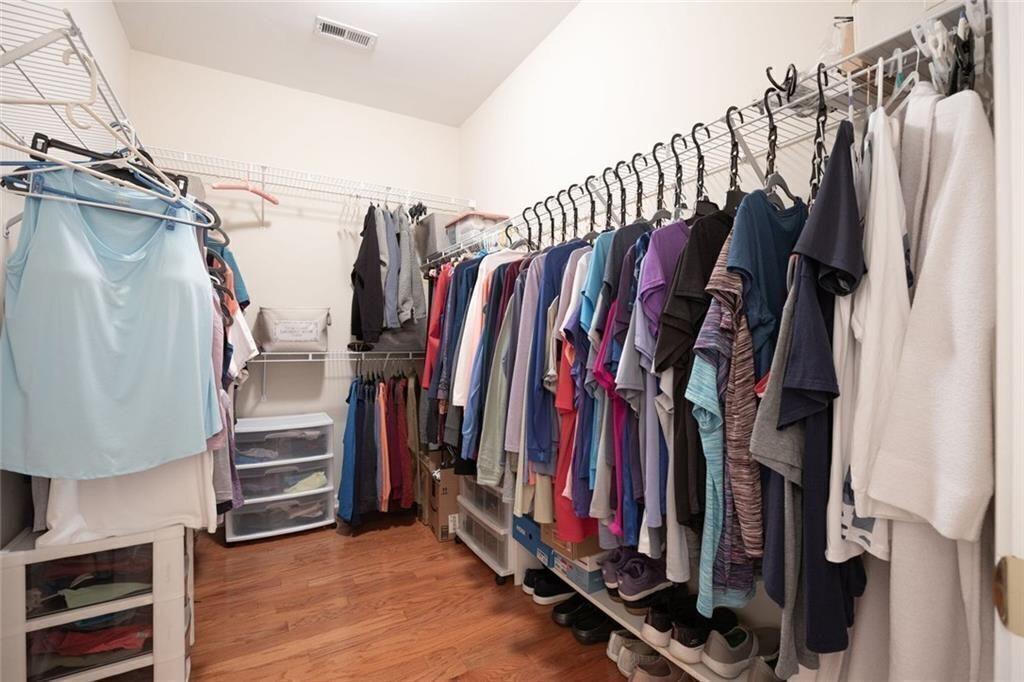 3807 Abbott Lane Southwest, Unit 15 Powder Springs, GA 30127 - Photo 24 of 32 a view of walk in closet with clothes and shoes