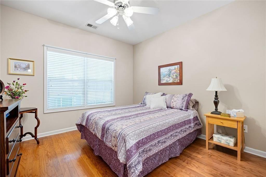 3807 Abbott Lane Southwest, Unit 15 Powder Springs, GA 30127 - Photo 25 of 32 a bedroom with a bed and a table in it
