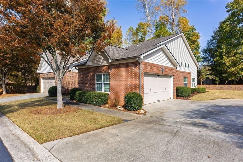 3807 Abbott Lane Southwest, Unit 15 Powder Springs, GA 30127 - Photo 32 of 32 a front view of a house with a yard and garage
