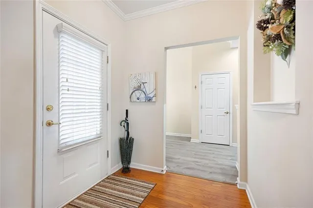 a view of a dining room with furniture a chandelier and wooden floor