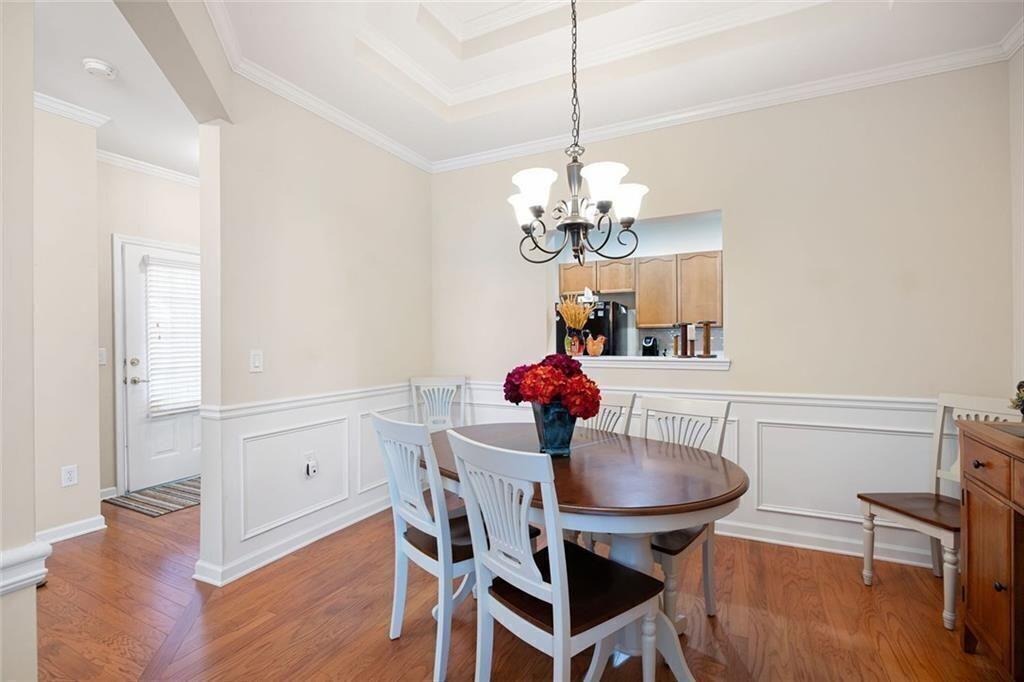 3807 Abbott Lane Southwest, Unit 15 Powder Springs, GA 30127 - Photo 6 of 32 a view of a dining room with furniture a chandelier and wooden floor