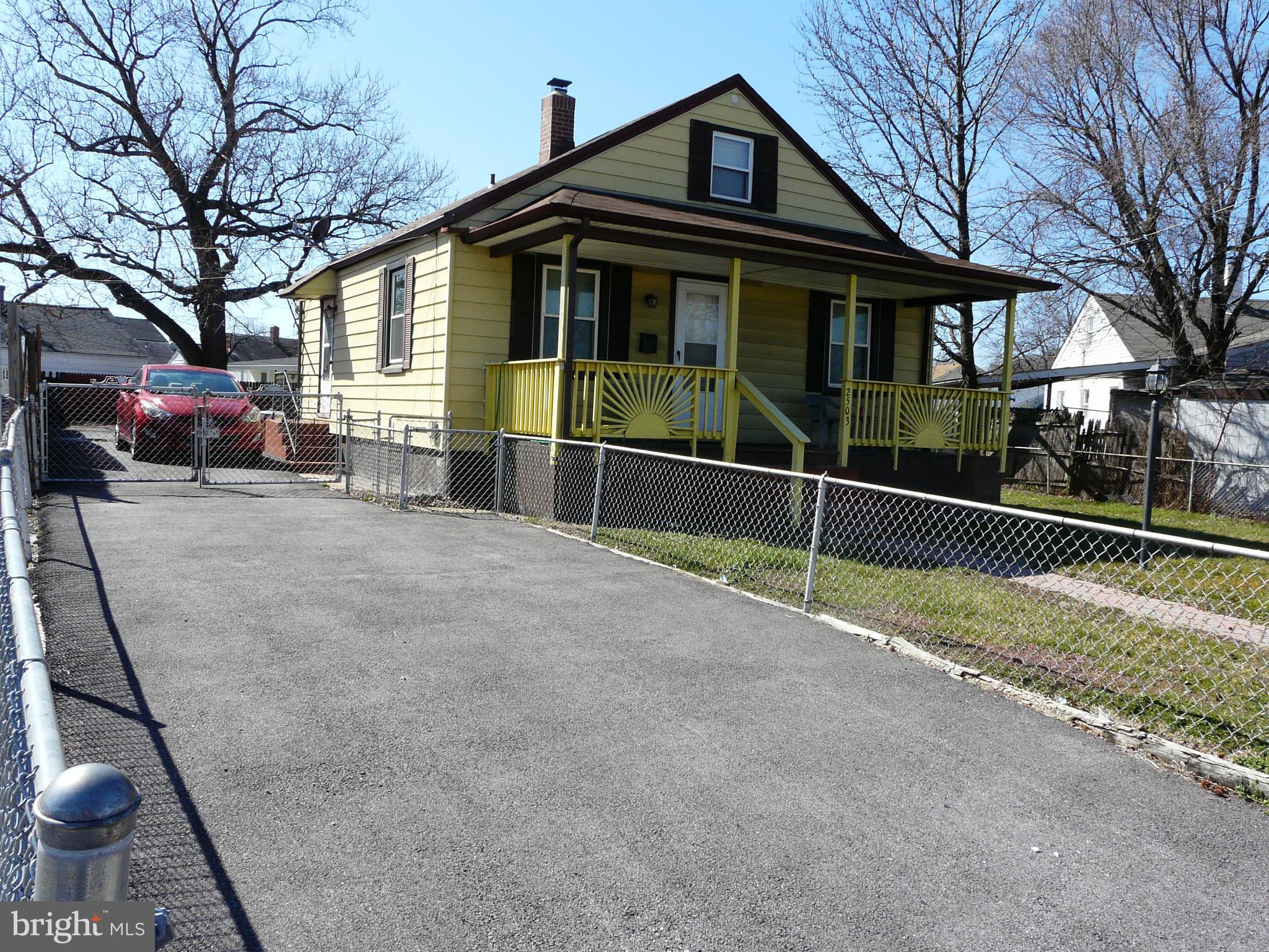 2503 North Point Road Baltimore, MD 21222 - Photo 3 of 16 a view of a house with a large window and wooden fence
