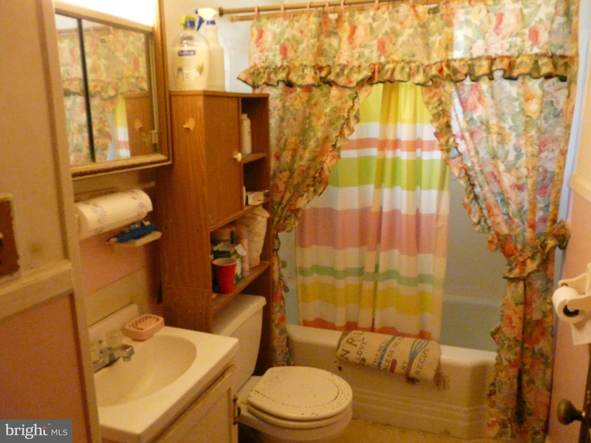 2503 North Point Road Baltimore, MD 21222 - Photo 8 of 16 a bathroom with a sink toilet and shower