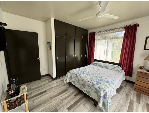 a bedroom with a bed and a dresser