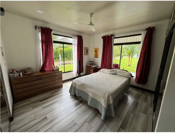 a bed sitting in a bedroom next to a window