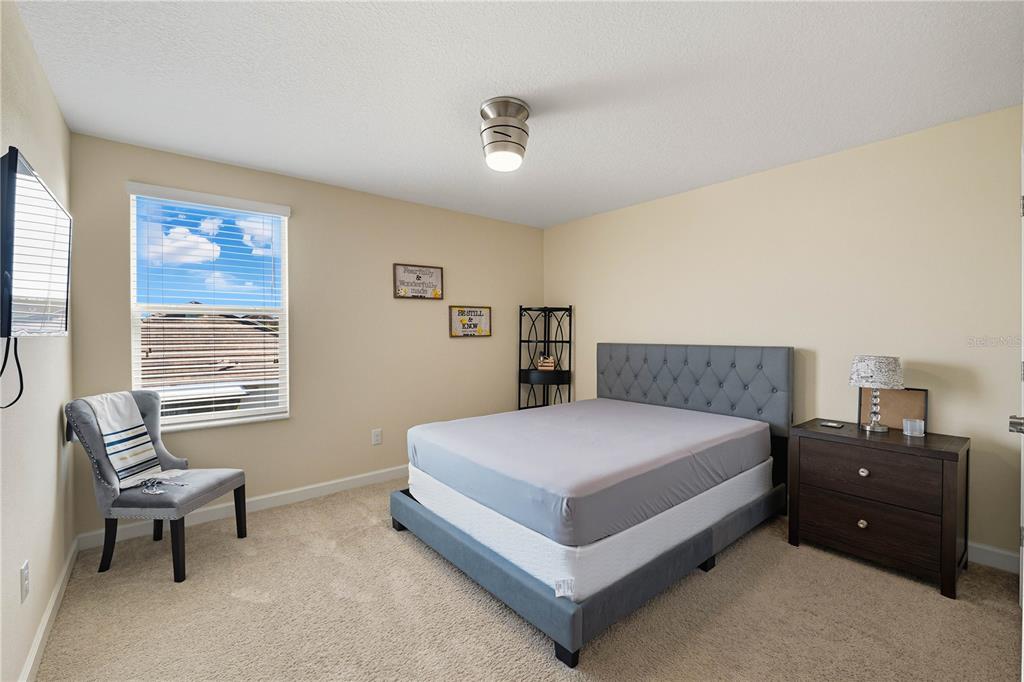 12041 Cardinal Flower Drive Riverview, FL 33579 - Photo 27 of 58 a bedroom with a bed and a couch