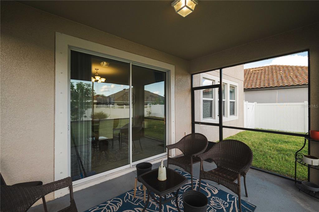 12041 Cardinal Flower Drive Riverview, FL 33579 - Photo 37 of 58 a living room with furniture and a floor to ceiling window