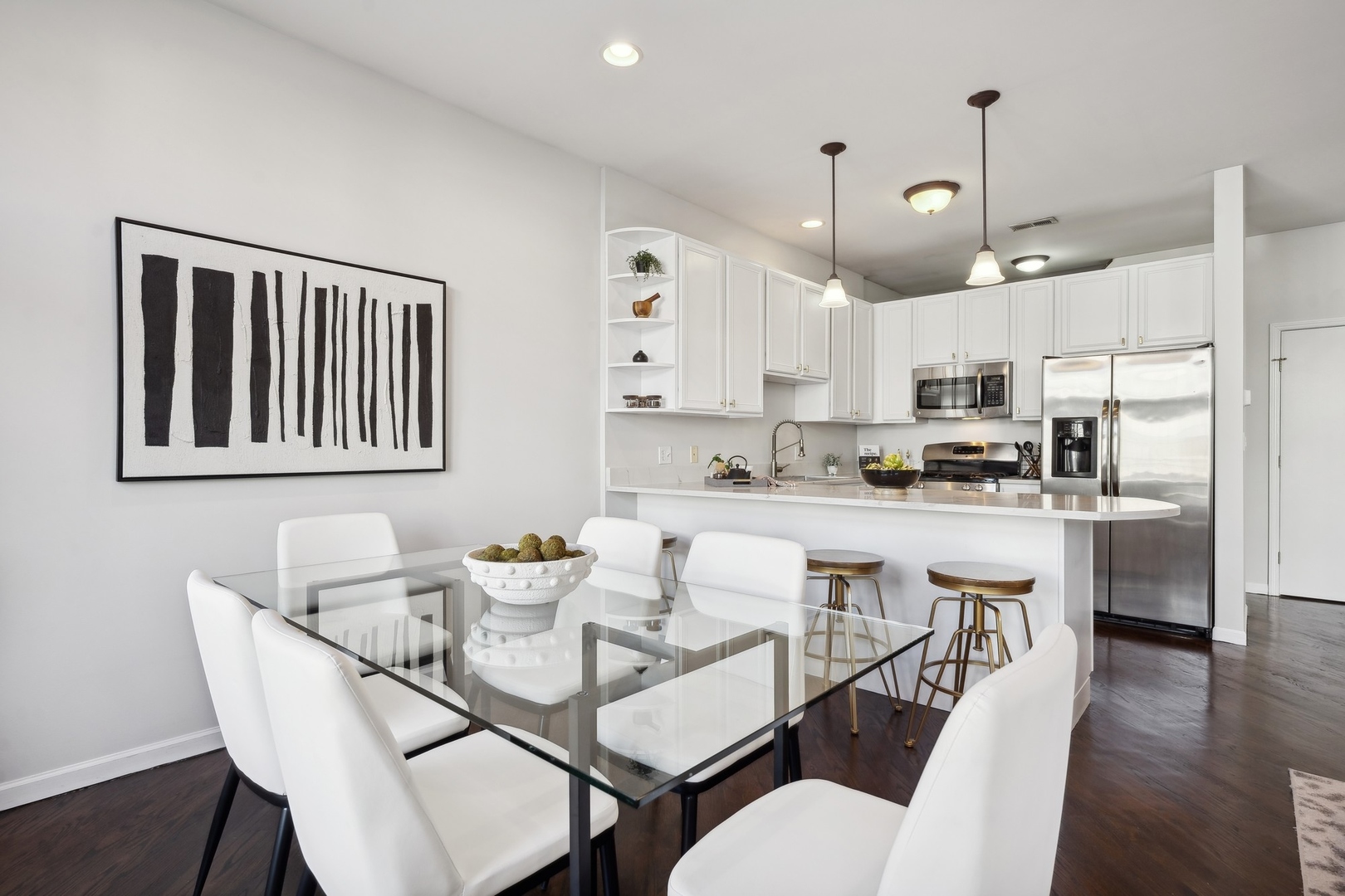 2124 West Division Street, Unit 3 Chicago, IL 60622 - Photo 14 of 33 a kitchen with stainless steel appliances kitchen island granite countertop a dining table chairs and a refrigerator