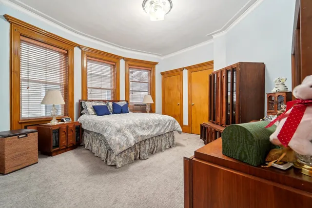 a bedroom with bed and wooden floor