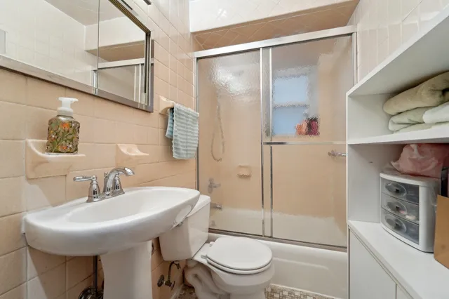 a bathroom with a sink toilet and shower
