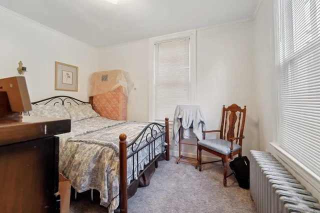 a bed room with a bed and a chair