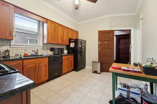 a kitchen with stainless steel appliances kitchen island granite countertop a sink dishwasher stove and refrigerator