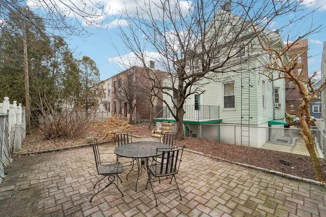 a view of a chairs and table in backyard