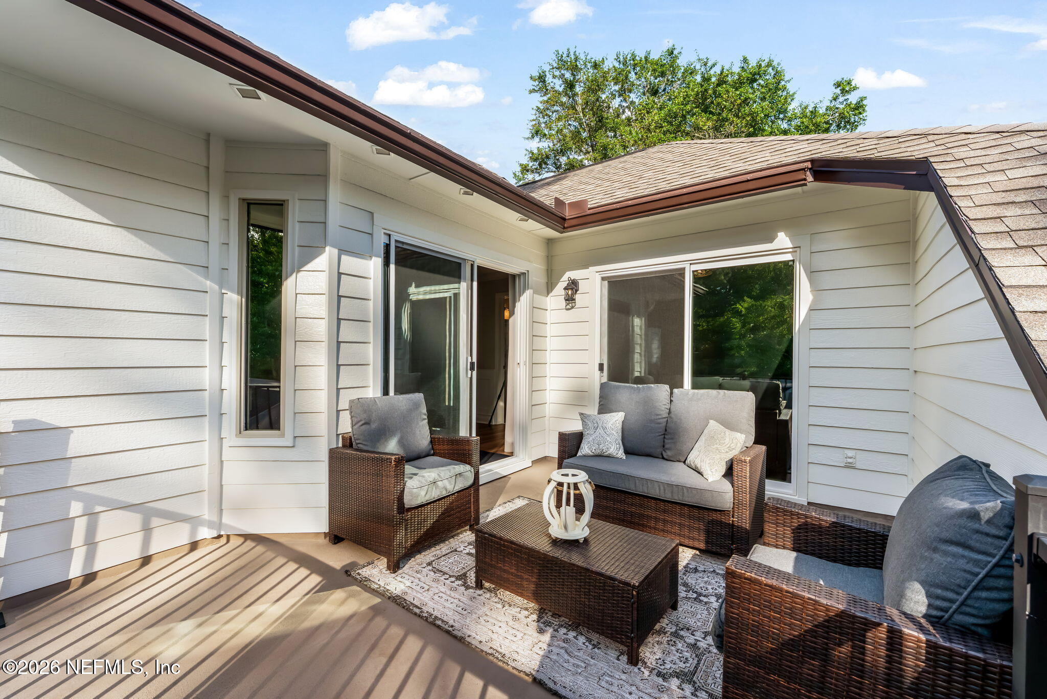 1204 Creek Bend Road St. Johns, FL 32259 - Photo 72 of 107 a view of a patio with couches chairs and potted plants