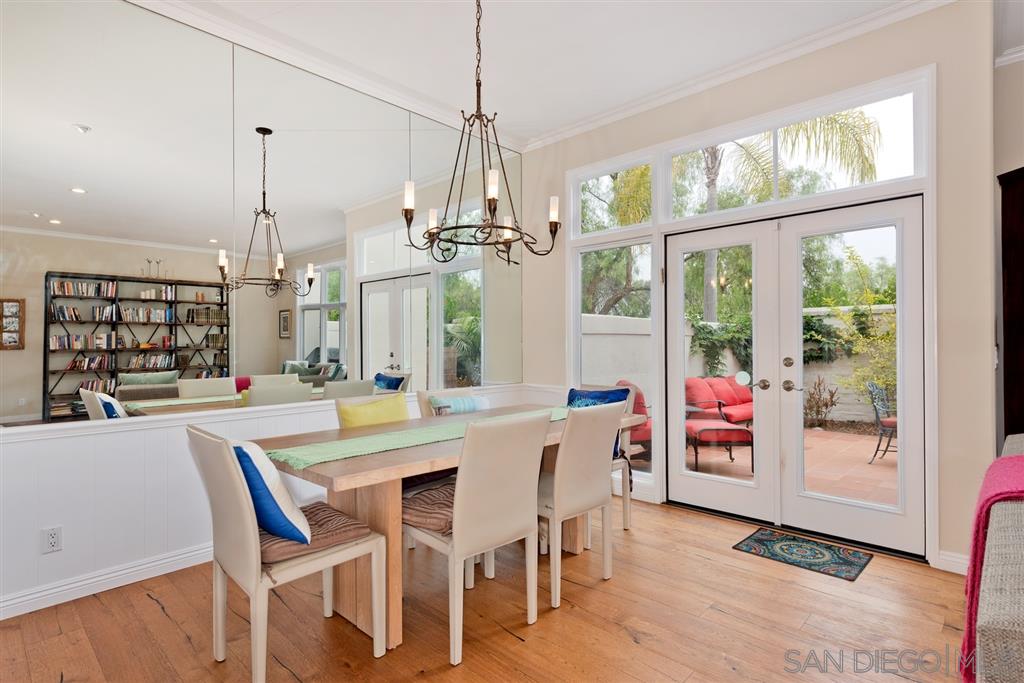 3138 Hamburg Square La Jolla, CA 92037 - Photo 12 of 25 a dining room with furniture a chandelier and wooden floor