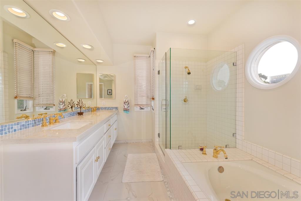 3138 Hamburg Square La Jolla, CA 92037 - Photo 21 of 25 a spacious bathroom with a tub sink mirror and a shower