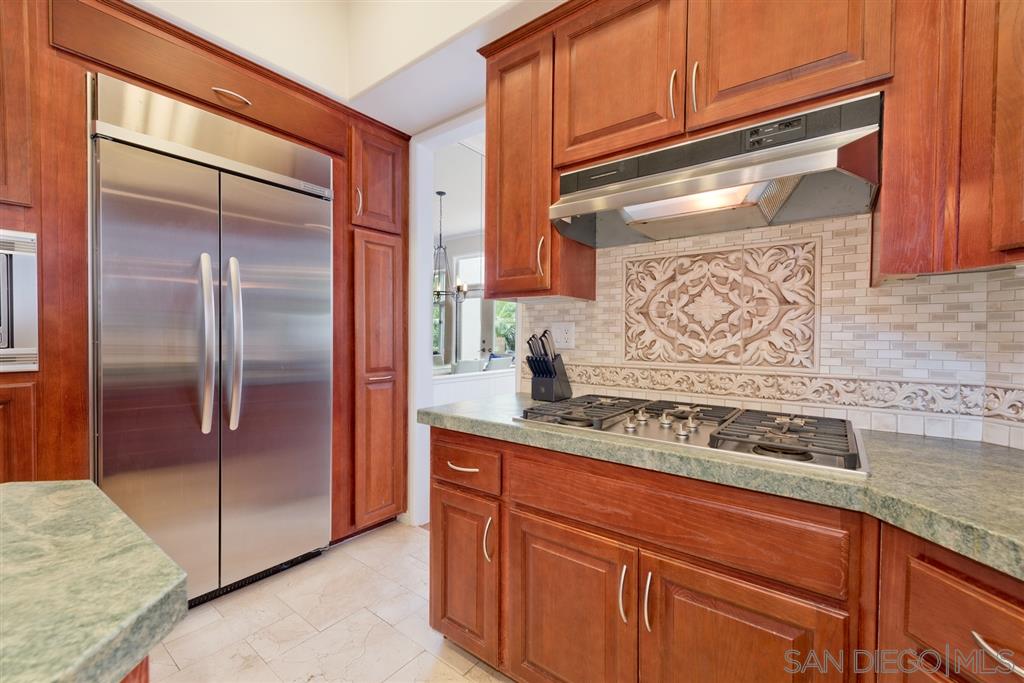 3138 Hamburg Square La Jolla, CA 92037 - Photo 8 of 25 a kitchen with stainless steel appliances granite countertop a refrigerator and a stove
