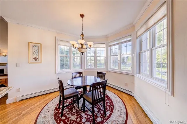 a view of a dining room with furniture wooden floor and chandelier