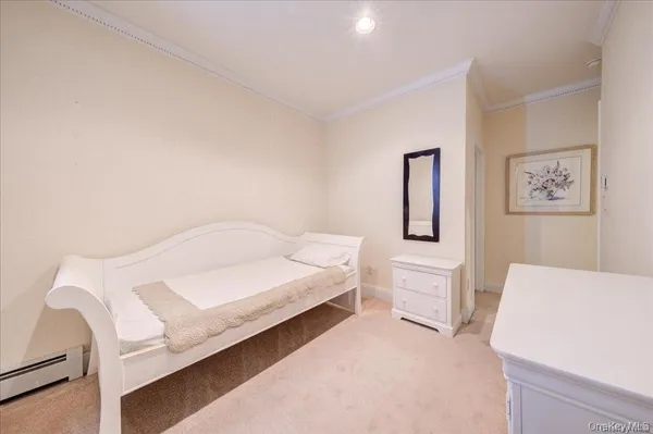 a spacious bedroom with a bed and a table in it