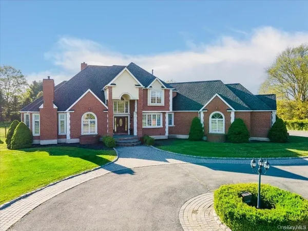 a front view of house with yard and green space