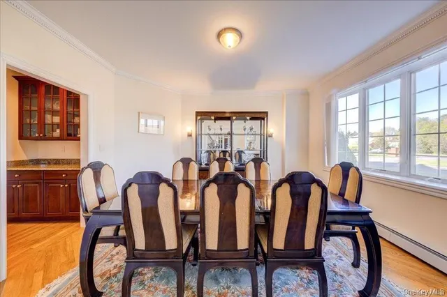 a view of a dining room with furniture a chandelier and wooden floor