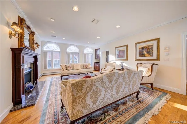 a living room with furniture a flat screen tv and a fireplace