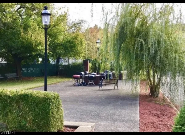 a view of a backyard with table and chairs and a large tree