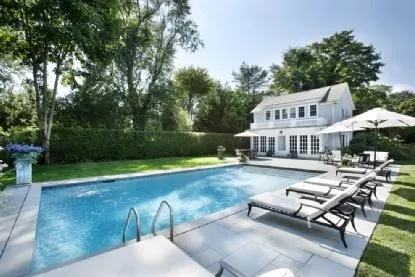 a view of a house with swimming pool and sitting area