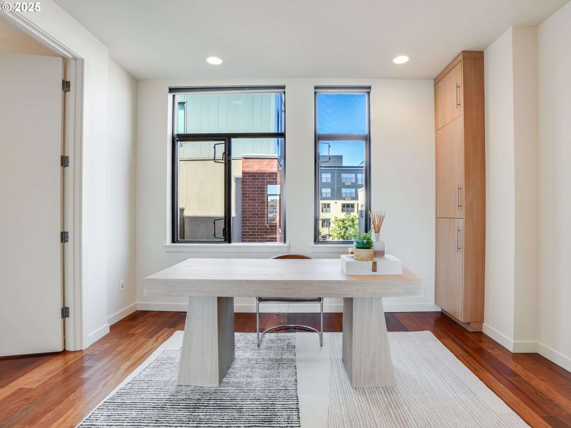1714 Northwest Riverscape Street Portland, OR 97209 - Photo 18 of 19 a large living room with a large window and table