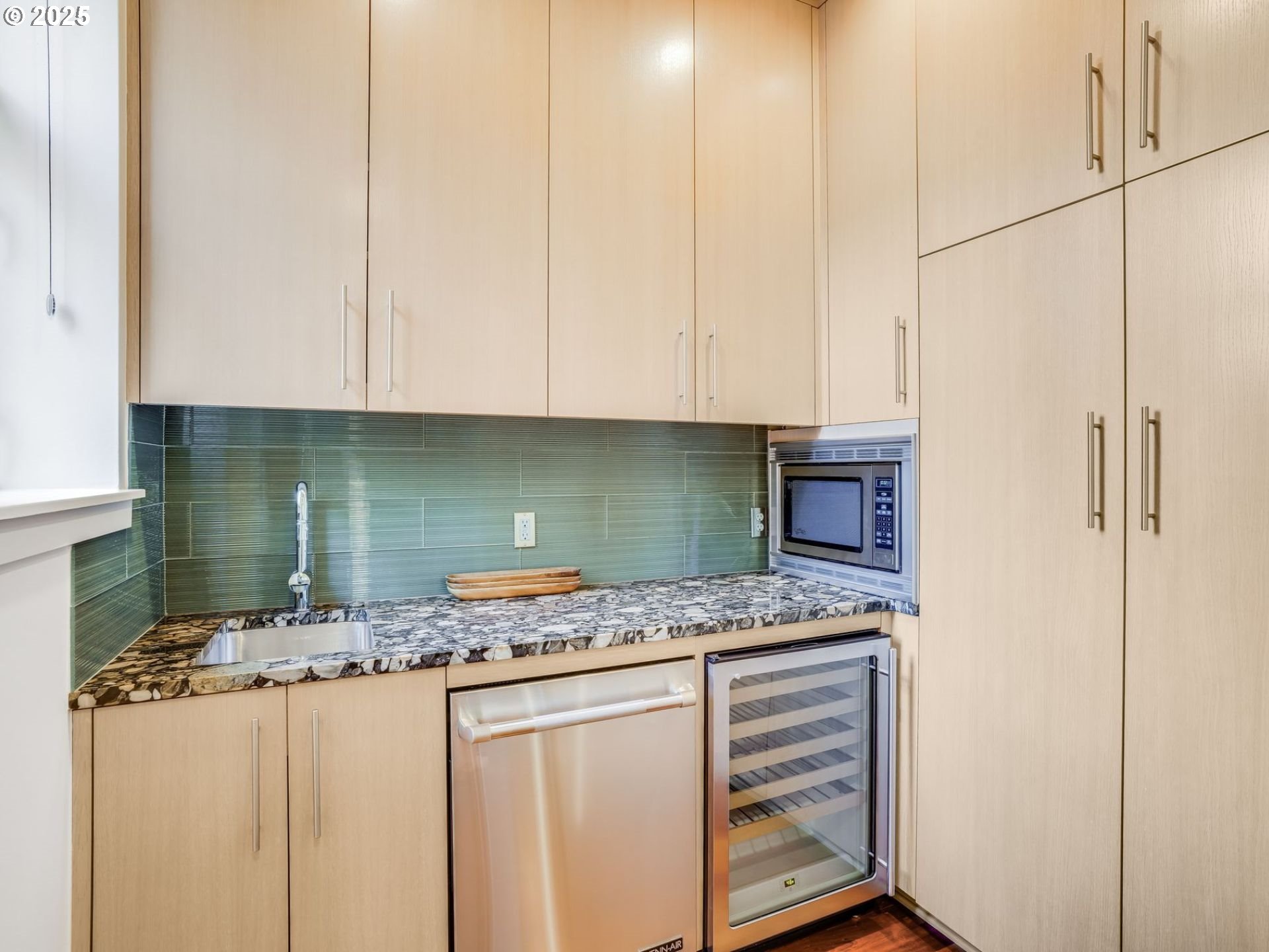 1714 Northwest Riverscape Street Portland, OR 97209 - Photo 7 of 19 a kitchen with white cabinets and sink