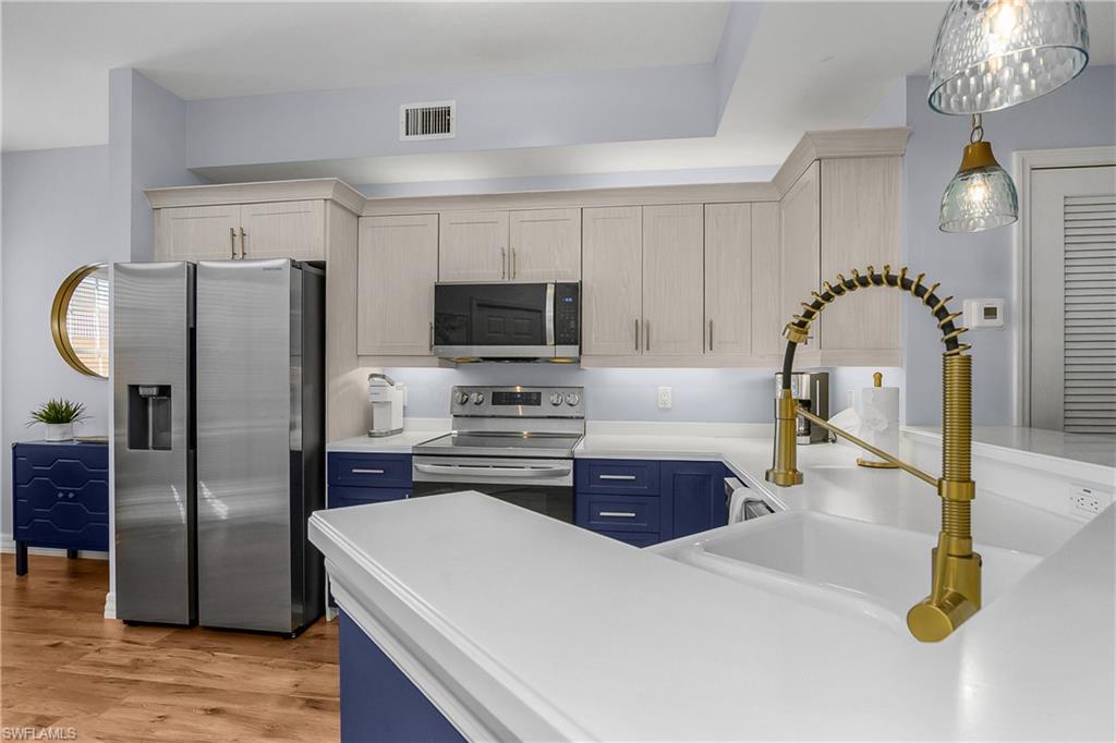 451 Bayfront Place, Unit 5201 Naples, FL 34102 - Photo 14 of 38 a kitchen with stainless steel appliances a refrigerator sink and stove