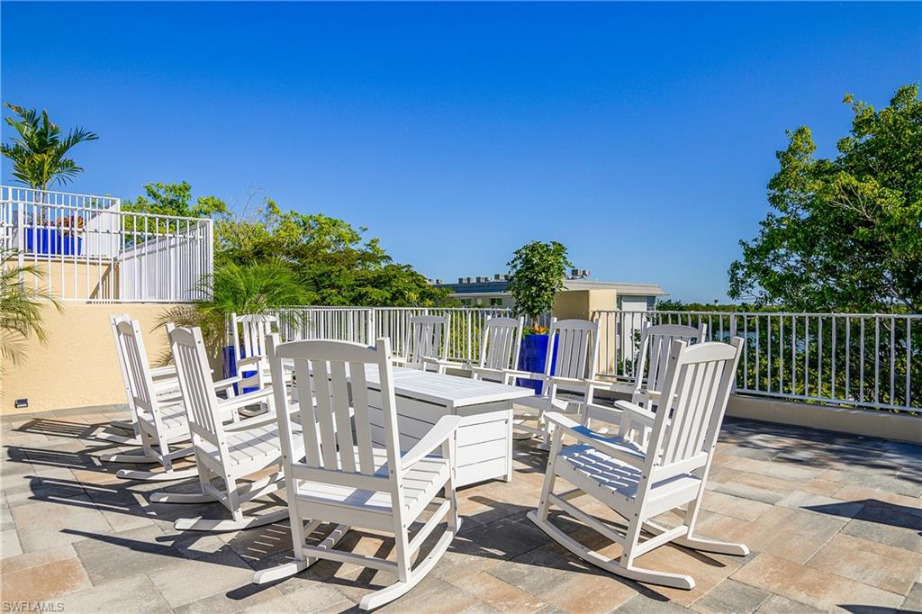 451 Bayfront Place, Unit 5201 Naples, FL 34102 - Photo 22 of 38 a view of a chair and table on the terrace