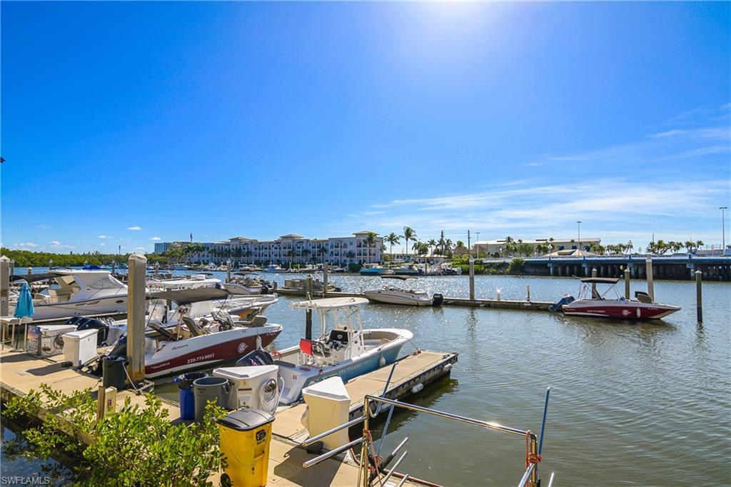 451 Bayfront Place, Unit 5201 Naples, FL 34102 - Photo 31 of 38 a view of a lake with lawn chairs