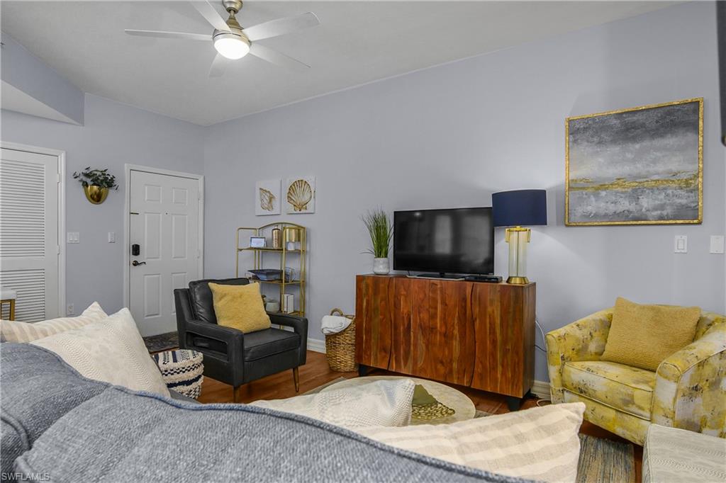 451 Bayfront Place, Unit 5201 Naples, FL 34102 - Photo 4 of 38 a living room with furniture and a flat screen tv