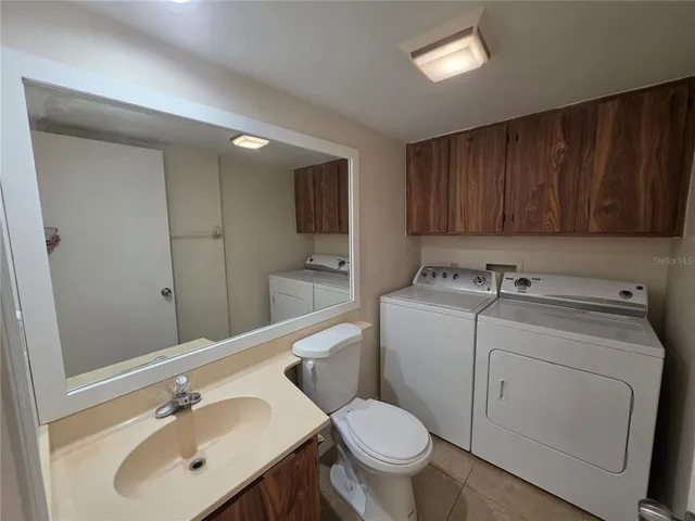 a view of cabinets and kitchen with a refrigerator