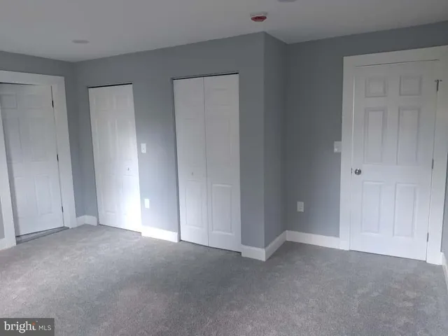 a view of an empty room and entryway