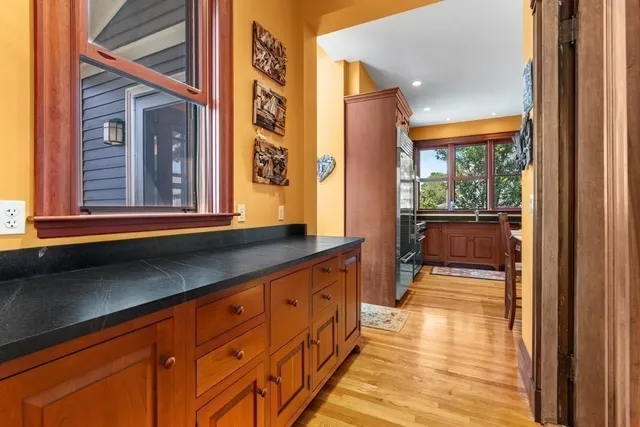 a kitchen with stainless steel appliances dining table and chairs