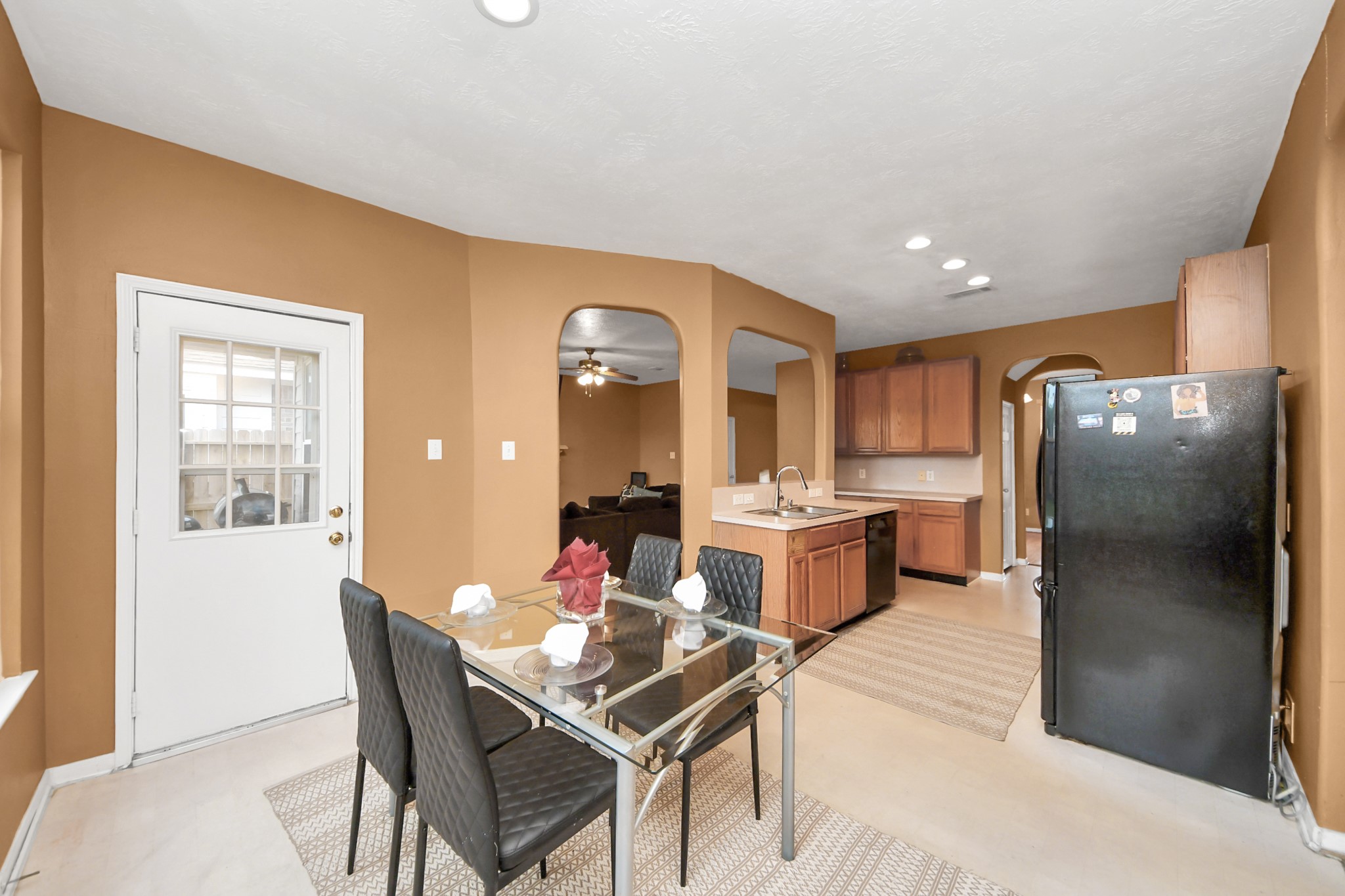 23814 Spring Dane Drive Spring, TX 77373 - Photo 22 of 41 a kitchen with a refrigerator and table chairs